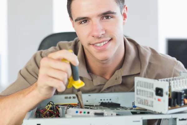 Handsome content computer engineer repairing open computer — Stock Photo, Image