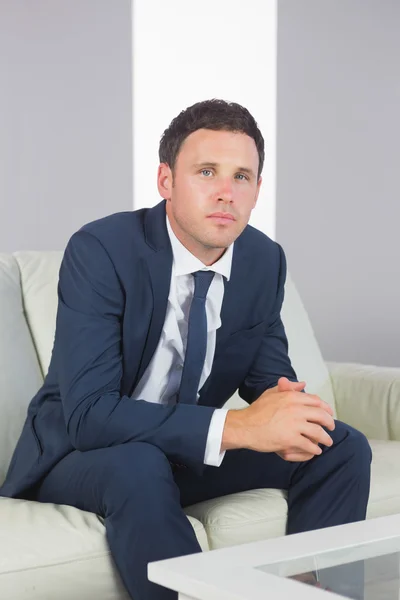 Serious handsome businessman relaxing on couch — Stock Photo, Image