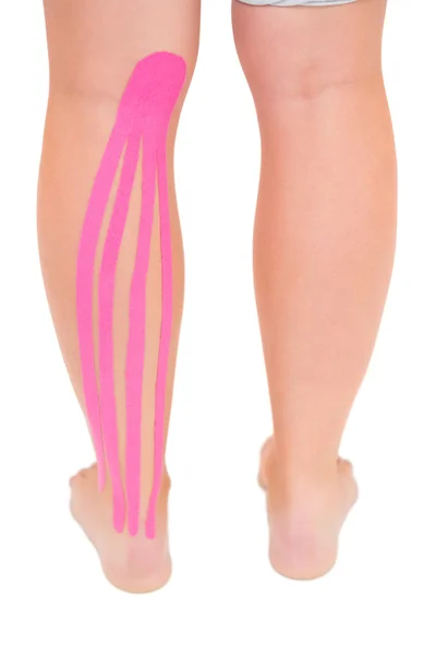 Patients leg with applied kinesio tape — Stock Photo, Image