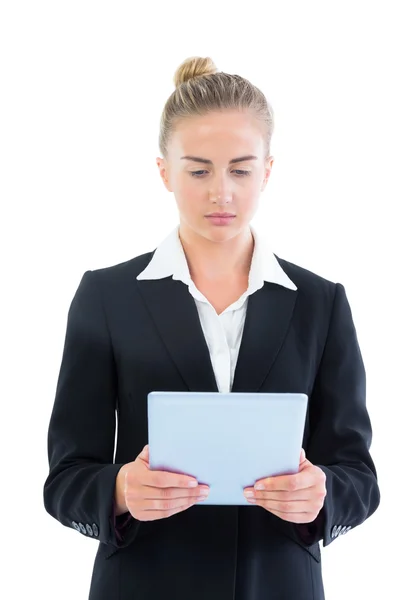 Profile view of concentrated young businesswoman using her tablet — Stock Photo, Image