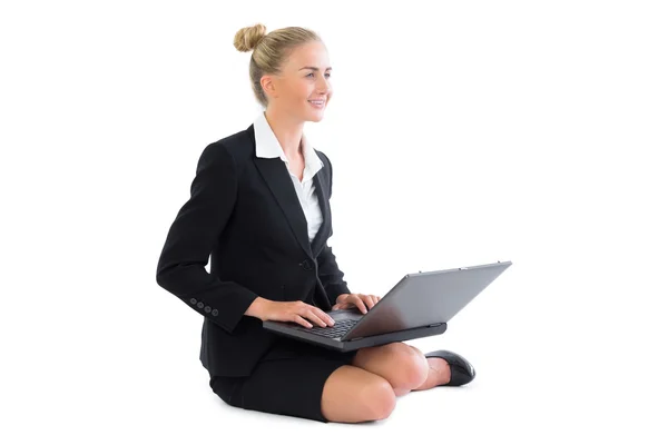 Amused businesswoman making use of her notebook — Stock Photo, Image