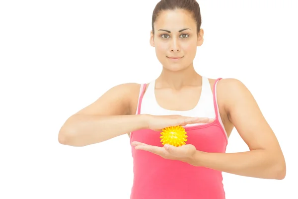 Content sporty brunette holding yellow message ball — Stock Photo, Image