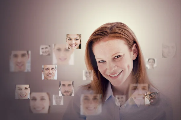 Glimlachende zakenvrouw omringd door digitale interface — Stockfoto