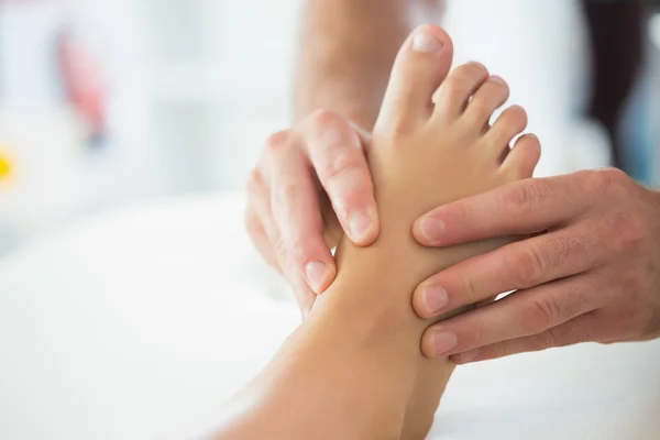 Close up of physiotherapist massaging patients foot — Stock Photo, Image