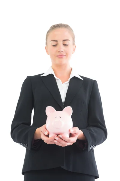 Ernstige jonge zakenvrouw houden van roze piggy bank — Stockfoto