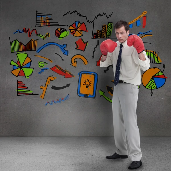 Üzletember, a boksz-kesztyűket, színes grafikus előtt áll — Stock Fotó