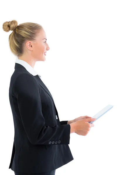 Profile view of pretty blonde businesswoman holding her tablet — Stock Photo, Image