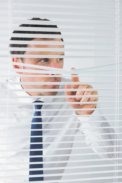 Good looking businessman spying — Stock Photo, Image