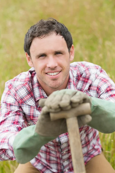 Улыбающийся мужчина позирует с лопатой — стоковое фото