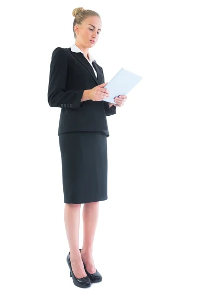 Low angle side view of attractive blonde businesswoman making use of her tablet — Stock Photo, Image