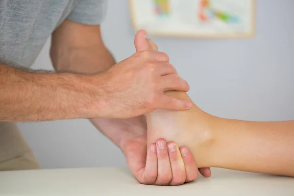 Physiotherapist controlling patients foot — Stock Photo, Image