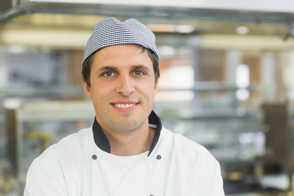 Happy male chef posing in a kitchen — Stock Photo, Image