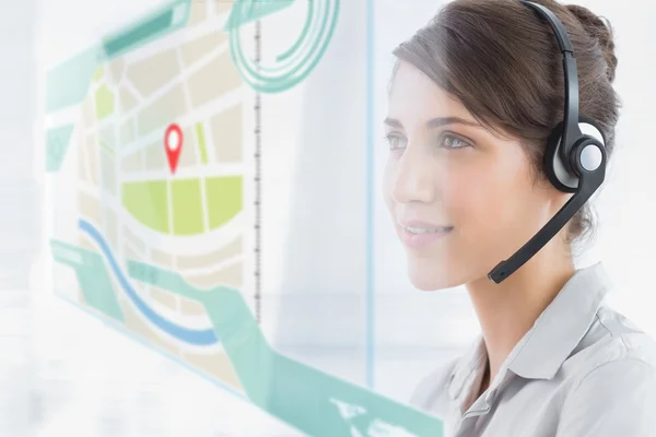 Happy call center employee using futuristic street map interface — Stock Photo, Image