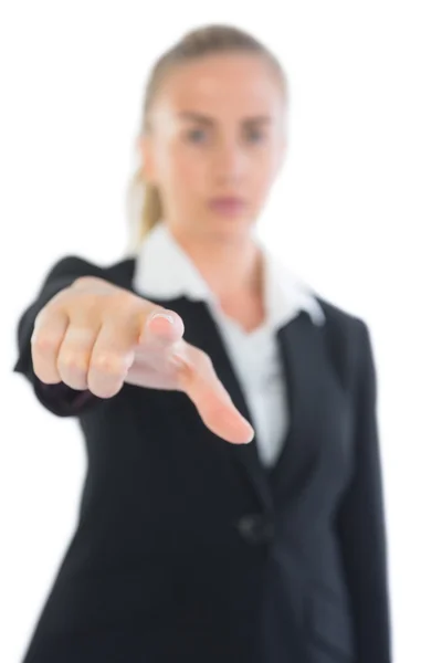 Serious pretty businesswoman pointing at camera — Stock Photo, Image