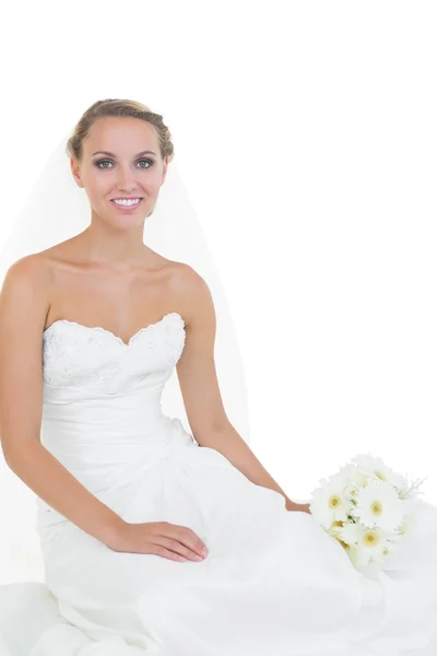 Cheerful young bride sitting on floor — Stock Photo, Image