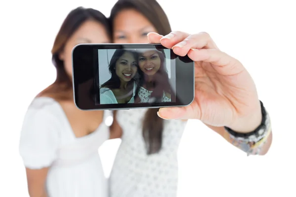 Two smiling asian sisters taking a self portrait — Stock Photo, Image
