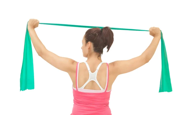 Rear view of sporty brunette stretching with resistance band — Stock Photo, Image