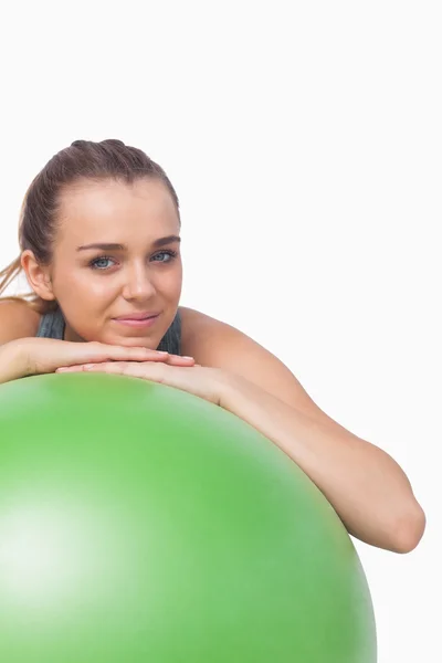 Mulher desportiva bonito sustentando-se com uma bola de fitness — Fotografia de Stock