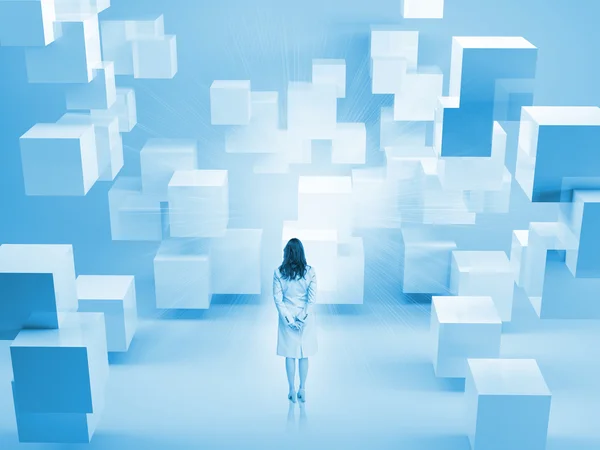 Rear view of businesswoman standing in room with blocks — Stock Photo, Image