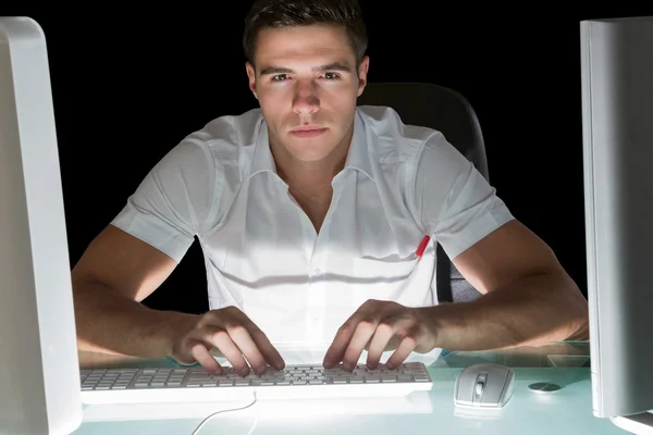 Handsome stern computer engineer working at night — Stock Photo, Image