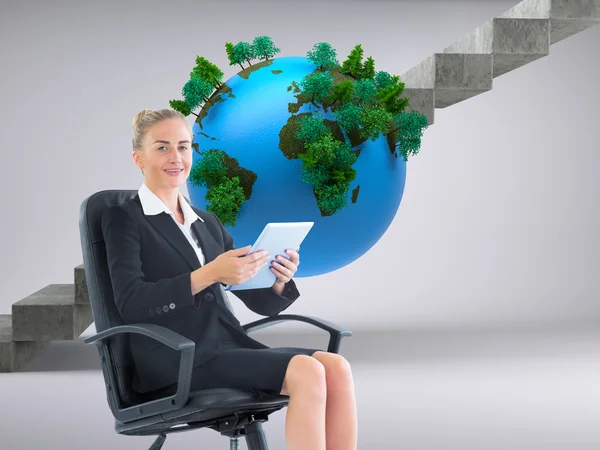 Composite image of businesswoman sitting on swivel chair with ta — Stock Photo, Image