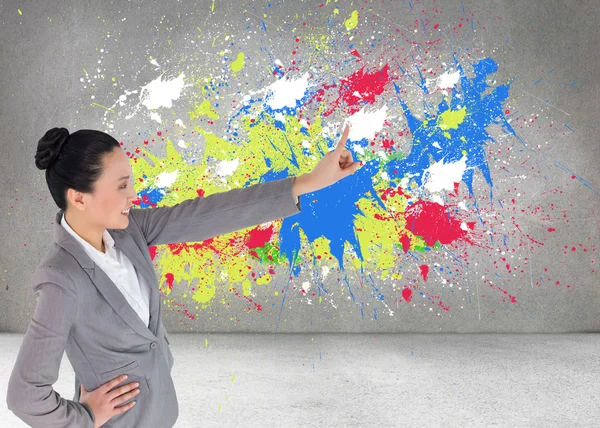 Composite image of smiling asian businesswoman pointing — Stock Photo, Image