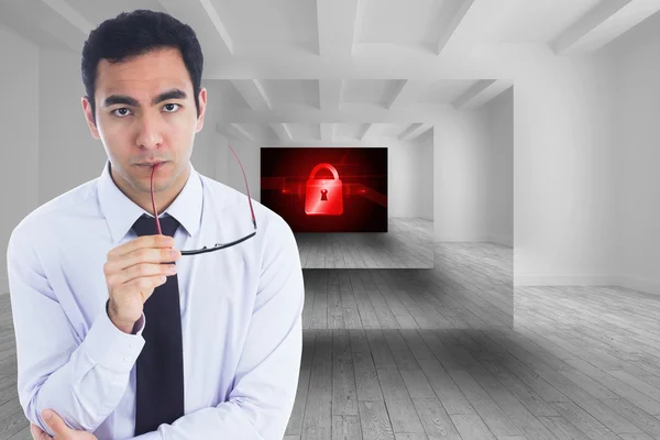 Unsmiling businessman holding glasses — Stock Photo, Image