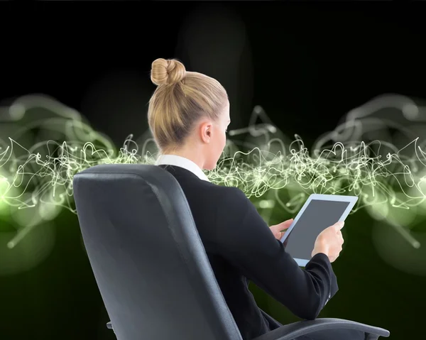 Businesswoman sitting on swivel chair with tablet — Stock Photo, Image