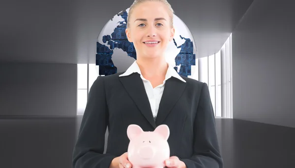 Samengestelde afbeelding van zakenvrouw houden piggy bank — Stockfoto