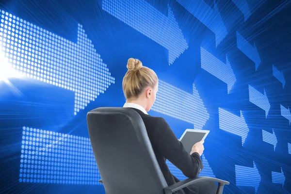 Composite image of businesswoman sitting on swivel chair with tablet — Stock Photo, Image