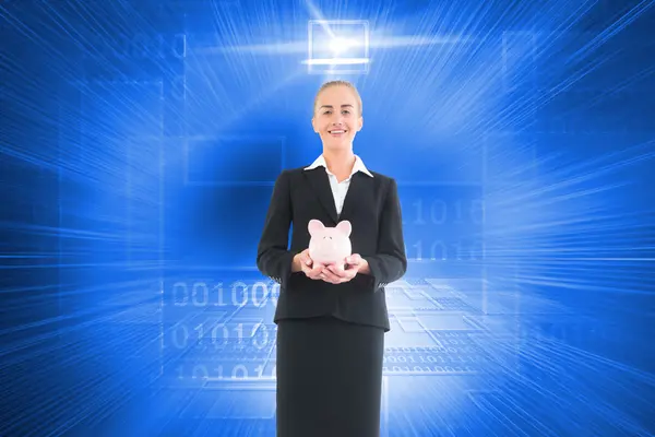 Composite image of businesswoman holding pink piggy bank — Stock Photo, Image