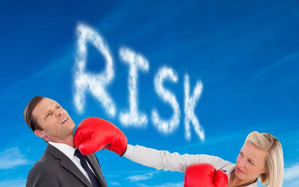 Businesswoman hitting colleague with her boxing gloves — Stock Photo, Image