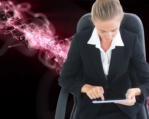 Businesswoman sitting on swivel chair with tablet — Stock Photo, Image