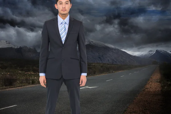 Composite image of serious asian businessman — Stock Photo, Image