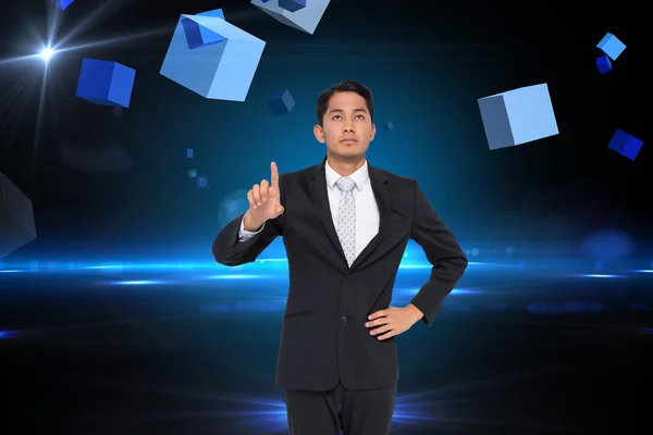 Composite image of unsmiling asian businessman pointing — Stock Photo, Image