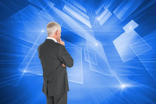 Composite image of thoughtful businessman standing back to camer — Stock Photo, Image