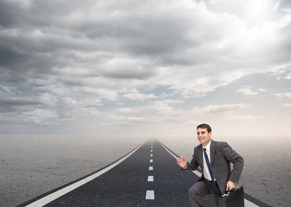 Happy businessman holding a briefcase and running — Stock Photo, Image