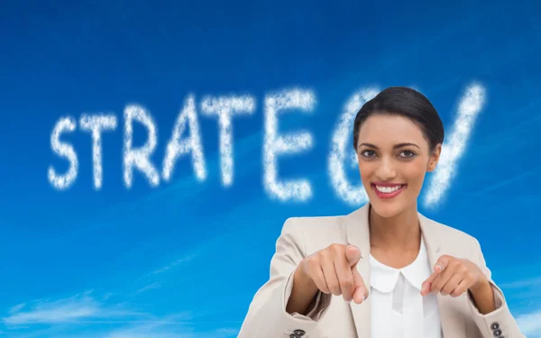 Smiling businesswoman pointing at the camera — Stock Photo, Image