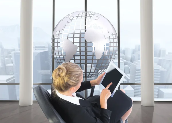 Composite image of businesswoman sitting on swivel chair with tablet — Stock Photo, Image