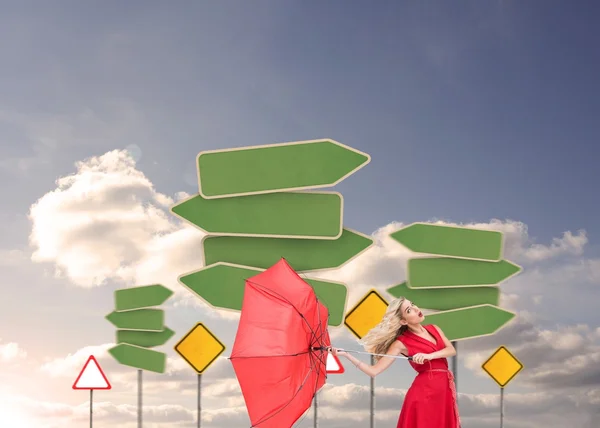 Attractive glamour woman holding a broken umbrella — Stock Photo, Image