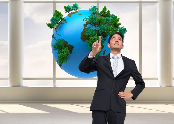 Composite image of unsmiling asian businessman pointing — Stock Photo, Image