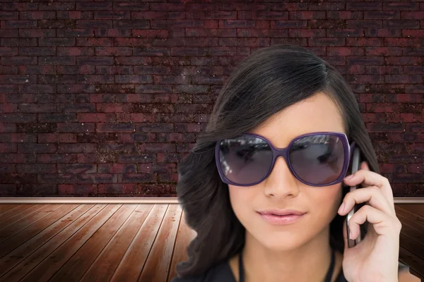 Elegant brunette wearing sunglasses on the phone — Stock Photo, Image