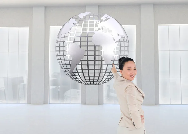 Composite image of smiling asian businesswoman pointing — Stock Photo, Image