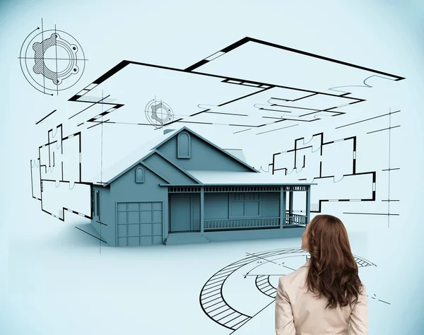 Brunette businesswoman looking at 3d house — Stock Photo, Image