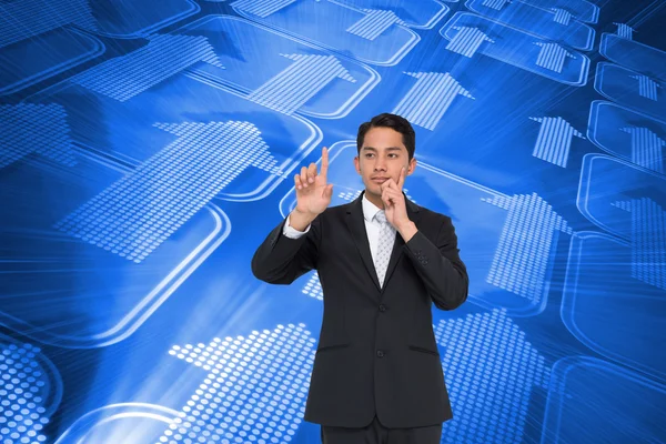 Composite image of thoughtful asian businessman pointing — Stock Photo, Image