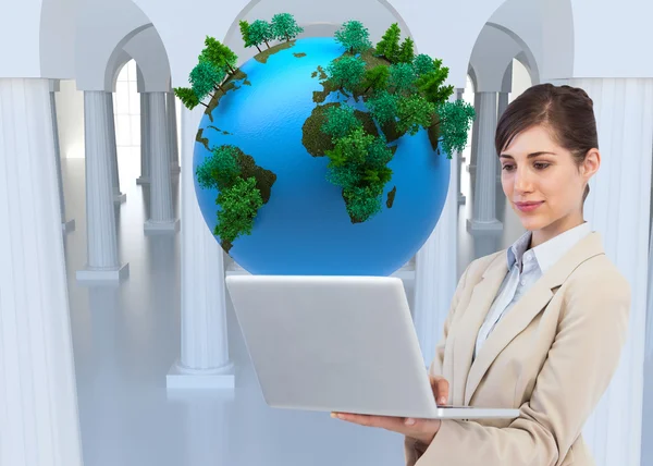 Confident businesswoman holding laptop — Stock Photo, Image