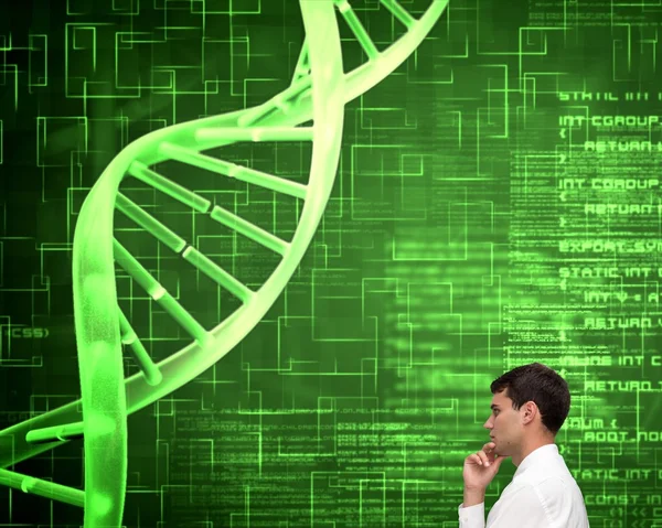Pensativo joven empresario mirando espiral de ADN — Foto de Stock