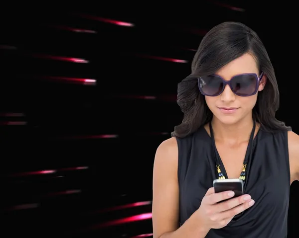 Morena concentrada usando gafas de sol mensajes de texto — Foto de Stock