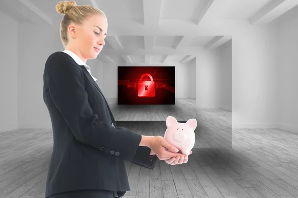 Composite image of businesswoman holding piggy bank — Stock Photo, Image