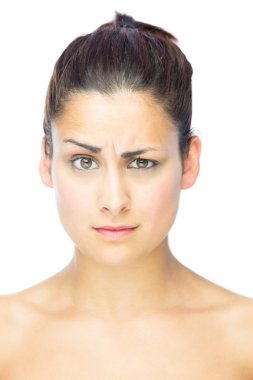 Front view of sceptical woman looking at camera clipart